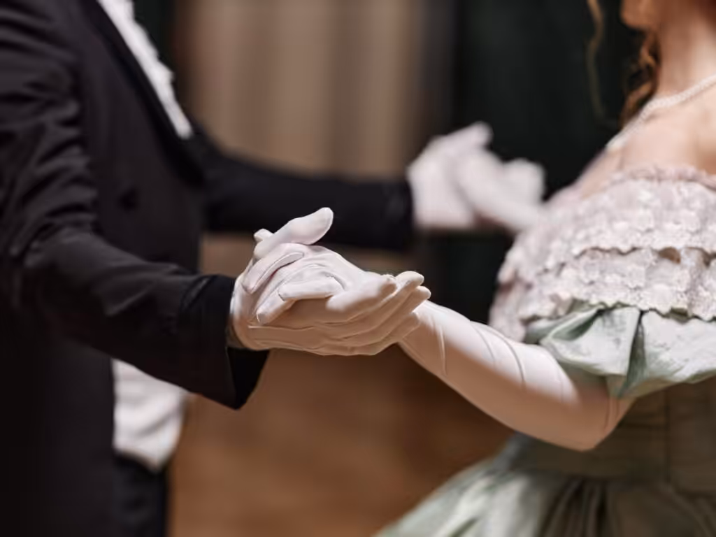Couple dancing at formal event in elegant attire.