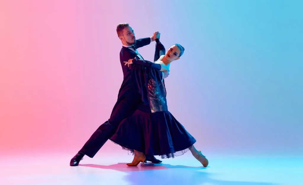 Elegant couple performing ballroom dance pose.